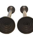 Bronze candle holders, close-up bottom view, lost wax cast style on white background.