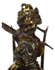 Bronze cherub doll sculpture with detailed smiling face, curly hair, seated holding an object, close-up view.