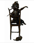 Bronze sculpture of a woman draped over a chair with one arm raised, small mouse at the base, close-up view.