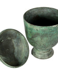 Close-up of green patina bronze urn with matching lid, lost wax cast, showing aged antique finish.