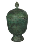 Bronze urn with verde gris patina and pointed finial, close-up against a white background.