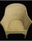 Natural rattan Burmese chair with curved back and sides on solid black background.