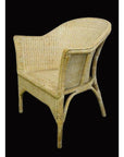 Brown rattan Burmese chair with curved back and woven seat, close-up against a black background.
