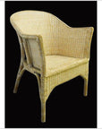 Light tan rattan chair with curved back and woven detail, close-up against a black background.