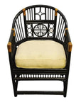 Brown rattan side chair with geometric patterns, tan cushion, and woven accents on arms and joints, front view.
