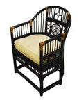 Brown rattan side chair with a curved back, beige cushion, and modern geometric patterns, indoor setting.