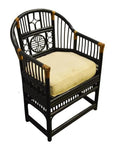 Black rattan side chair with decorative backrest and white cushioned seat, close-up view.