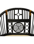 Close-up of black rattan Burmese side chair backrest with geometric and circular patterns, tan binding detail.
