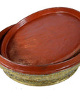 Close-up of two red lacquered Burmese offering bowls with ornate mica inlay and gilt bases, one stacked inside the other.