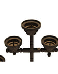 Black metal candle holder with four round holders in geometric design, displayed on a white background.