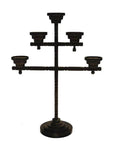 Black metal candelabra with five candle holders and round base, close-up, ideal for home décor.