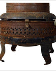 Black metal Chautauqua oil kerosene stove with ornate legs and side vent, isolated on white background.
