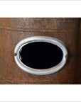 Close-up of weathered metal Chautauqua oil and kerosene stove with silver rim and oval opening.