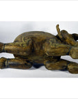 Brown wood elephant sculpture with intricate carvings, lying on its side, shown in good condition.