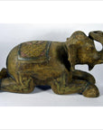 Bronze elephant statue with ornate carvings and blanket, kneeling, in good condition.