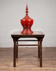 Large red urn with lid on Chinese 19th-century elmwood center hall table with Ming Dynasty stone inset.