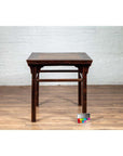Brown elmwood center hall table with Ming Dynasty stone inset, Chinese 19th c., on wooden floor, color card in front.