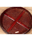 Brown wooden tiered Chinese food basket with red characters, stacked parts on a wooden surface.