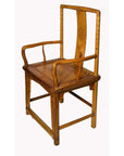 Brown Yumu wood chair with square back, hand-carved medallion, Greek key pattern, and decorative carvings.