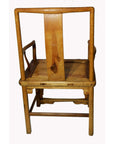 Brown Yumu wood chair with square back, hand-carved medallion, Greek key pattern, and decorative carvings.