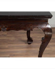 Black lacquered wood hall table with cabriole legs, shown indoors on a wooden floor.