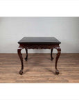Black lacquered wood hall table with cabriole legs and claw feet, positioned on a wooden floor indoors.