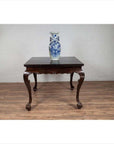 Blue and white porcelain vase on black lacquered Chinese antique hall table with cabriole legs.