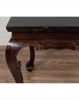 Black lacquered wood hall table with cabriole legs, displayed indoors on a wooden floor by a light wall.