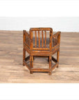 Brown bamboo frame child's corner chair with hexagonal base on wooden floor indoors.