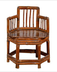 Brown bamboo corner chair with hexagonal base, antique Chinese style, wooden frame, photographed indoors.