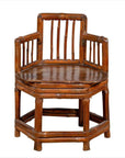 Brown bamboo corner chair with hexagonal base, antique Chinese style, wooden frame, photographed indoors.
