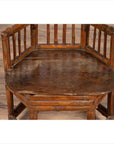 Brown bamboo child's corner chair with hexagonal base, antique style, shown indoors against a plain background.