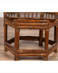 Close-up of a brown bamboo Chinese antique child's corner chair with hexagonal base.