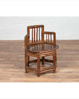 Brown bamboo child's corner chair with hexagonal base on wooden floor next to a white brick wall indoors.