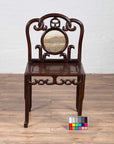 Dark rosewood Chinese antique side chair with open fretwork and marble medallion on a wooden floor.
