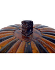 Close-up of a Chinese bamboo rice basket with a ridged metal lid and small sculpted animal handle.