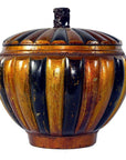 Close-up of a round Chinese bamboo rice basket with gold and black stripes and a small ornate top handle.