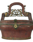 Brown bamboo wedding basket with ornate brass detailing and metal handle, close-up against a neutral background.