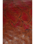 Close-up of a brown and red textured Chinese basket with abstract leaf-like patterns on the surface.