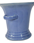 Close-up of blue celadon porcelain planter with flared rim, side handle, and crackle glaze.