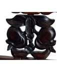 Close-up of dark wood carving showing peaches, leaves, and a flower from a Chinese rosewood chair, early 20th century.