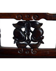 Close-up of carved dark wood peaches and leaves detail on Early 20th Century Chinese rosewood chair.