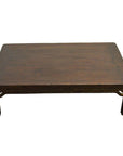 Dark wood Chinese coffee table with carved friezes and straight legs on a plain white background.