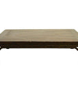 Brown wood Chinese coffee table with carved friezes, rectangular top, and short sturdy legs against white background.