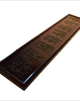 Brown Chinese elm wood sign with carved calligraphy, angled display on a white background.