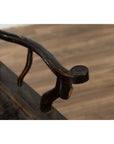 Close-up of dark patina elmwood armrest with visible scratches, worn surface, detailed texture shown.