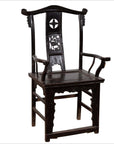 Dark patina elmwood chair with ornate carvings and rectangular seat, indoor setting.