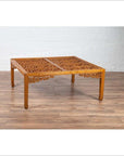 Brown elmwood square coffee table with open fretwork and horse-hoof legs on a wood floor indoors.