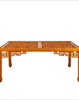 Brown elmwood square coffee table with open fretwork sides, horse-hoof legs, and a lattice-patterned top indoors.