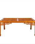 Brown elmwood square coffee table with open fretwork sides, horse-hoof legs, and a lattice-patterned top indoors.